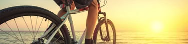 a person riding a bike on a beach