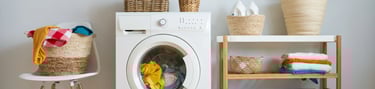 a washing machine with a basket of towels and a basket of towels