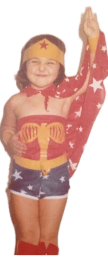 a young girl dressed in a wonderful woman costume