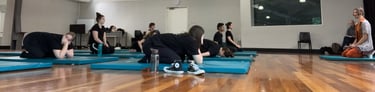 a group of people in a gym room