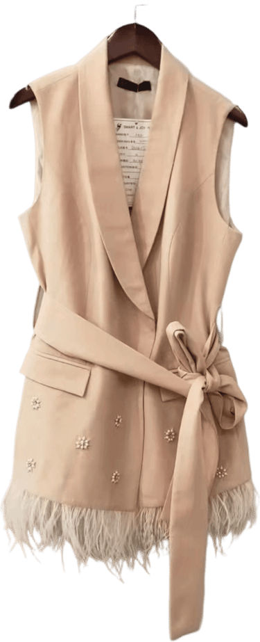 a beige vest with a white lace trimming