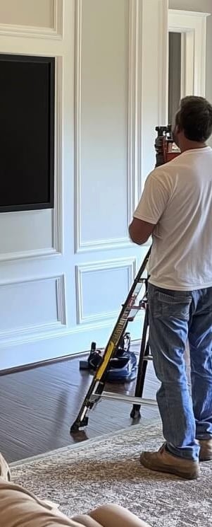 tv installer mounting tv on wood panel wall