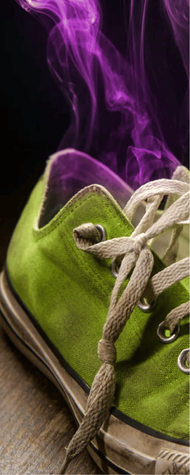  A single green sneaker emits purple smoke, symbolizing a strong, bad odor.