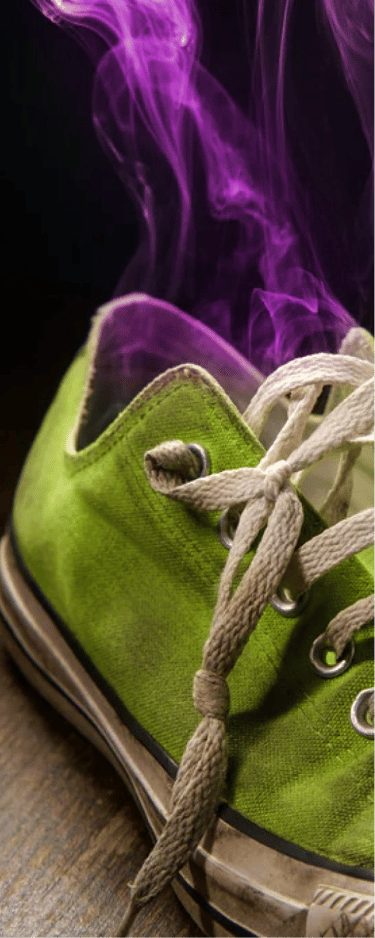  A single green sneaker emits purple smoke, symbolizing a strong, bad odor.