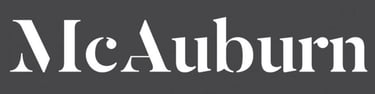 a black and white logo with the words,'McAuburn' '