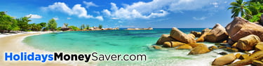Perfect Beach with Golden Sand and Blue Sky, with Trees and Beach Huts in the Background