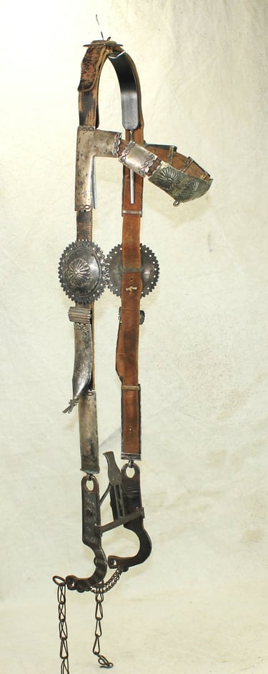 Vintage Western bridle with intricate leather tooling and silver conchos, perfect for collectors.