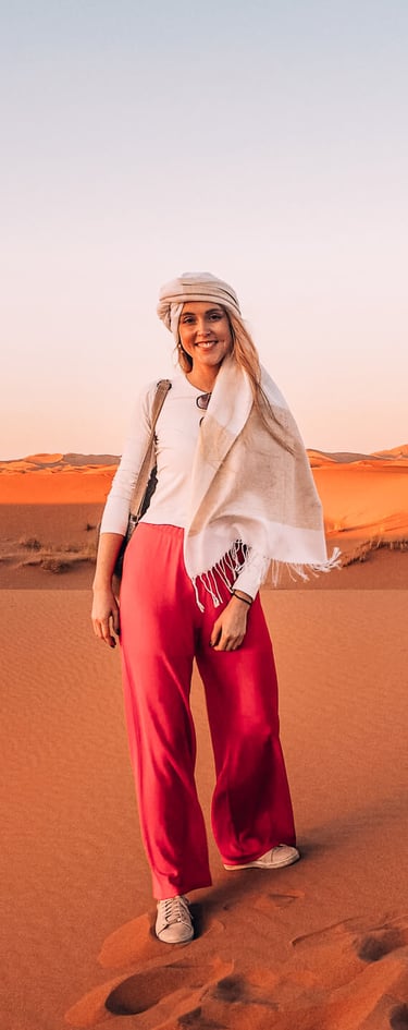 a woman in a white shirt and red pants