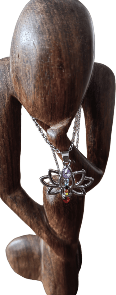 a wooden sculpture of a woman holding a necklace with a butterfly