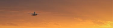 Airliner, airplane takeoff at sunset or sunrise