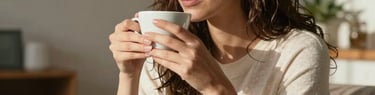 A relaxed portrait of a confident woman enjoying a quiet cup of tea in a sun-drenched modern apartment in Spain / Latin America, feeling grounded and present, soft warm tones.
