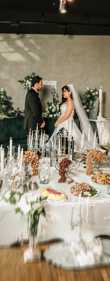 Bride and groom facing each other at Sofreh Aghd setup, captured by Fred Art Studio