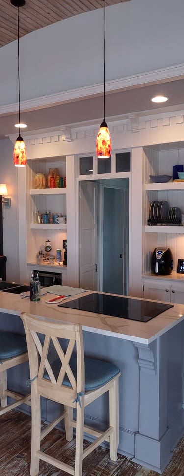a kitchen with a large island and bar stools