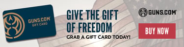 Guns.com gift card banner with American flag background and text that says Give the Gift of Freedom. Grab a gift card today a