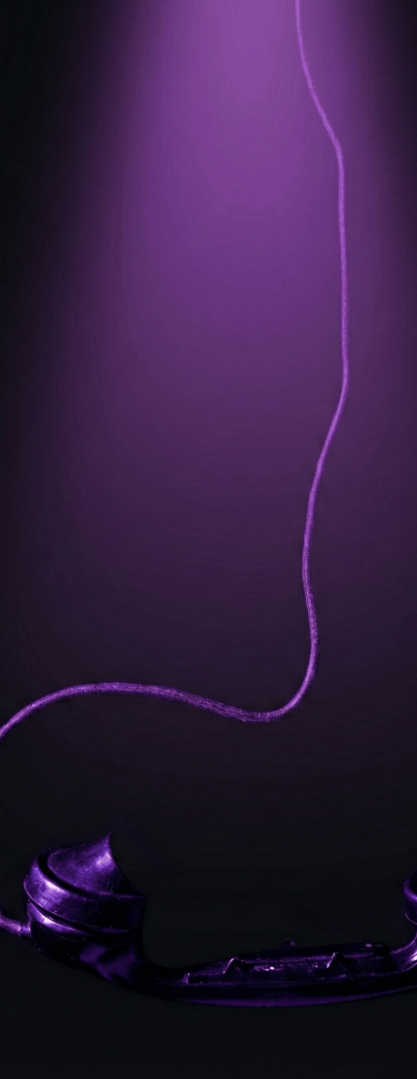 a telephone booth with a purple light shining on it