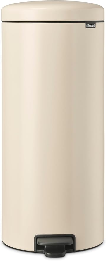 a cream colored trash canister with a black handle