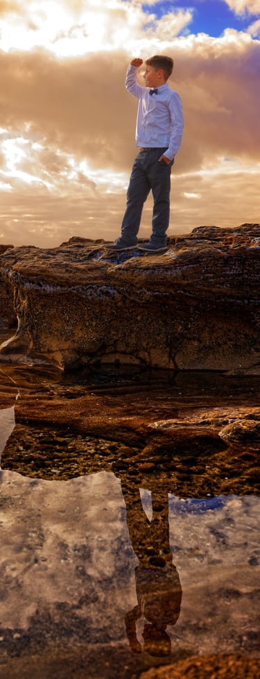 a man standing on a rock with a camera