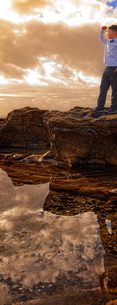 a man standing on a rock with a camera