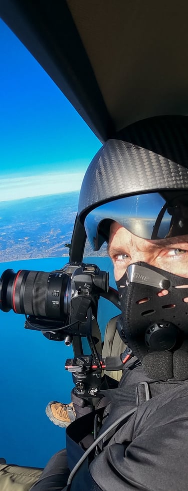 a man in a helmet and goggles is taking a picture of a man in