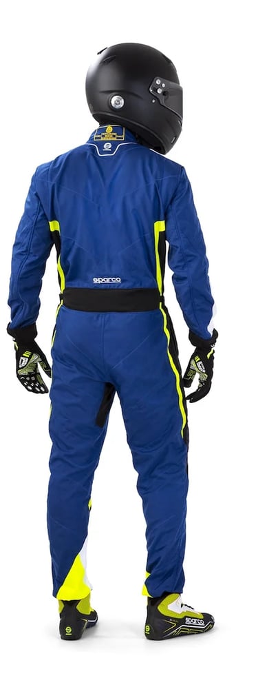 Rear view of a driver wearing a blue Sparco racing suit and black helmet on a white background.