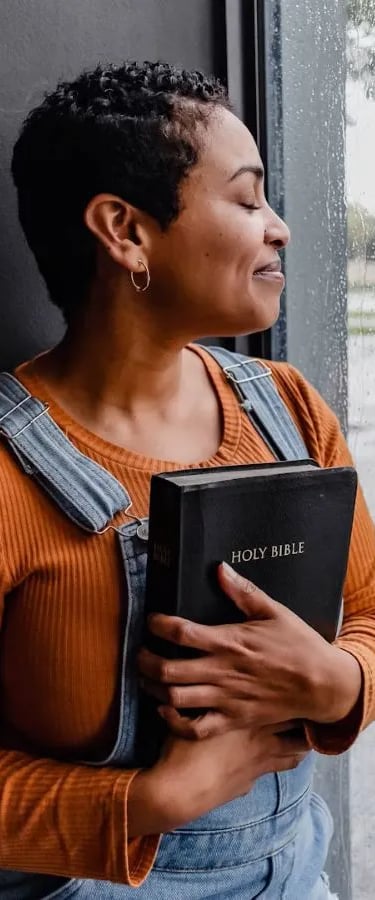woman holding smiling from bible answers she got from bible