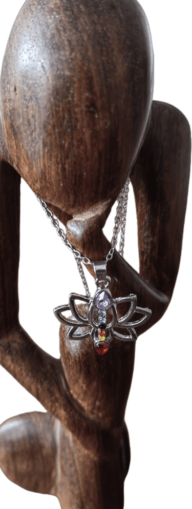 a wooden sculpture of a woman holding a necklace with a butterfly