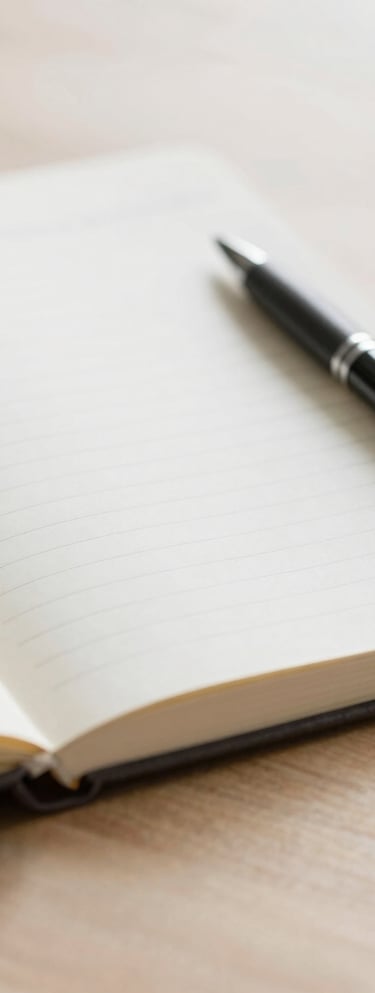 person holding pencil near laptop computer