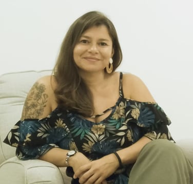 a woman therapist sitting on a couch in a therapy room
