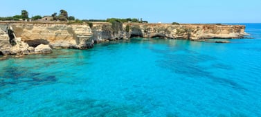 Faraglioni di Sant Andrea during a sunny day and with light blue sea