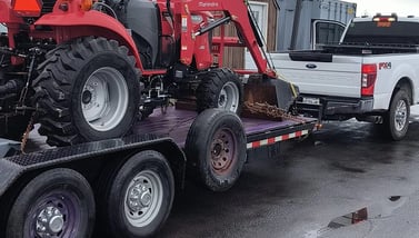 A tractor on a flatbed Trailer