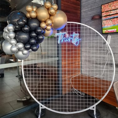 Circle backdrop with small garland and thirty neon for birthday at Chatswood Hill Tavern, Logan.