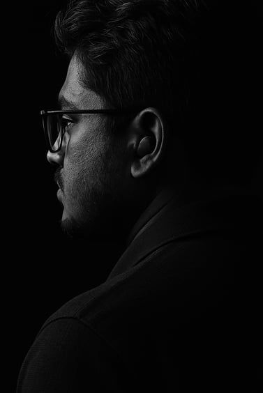 a man in glasses and a black shirt