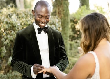 Groom placing the wedding ring on the bride's finger during elopement ceremony in Provence
