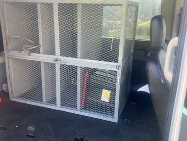 a van with a cage caged in to a cage