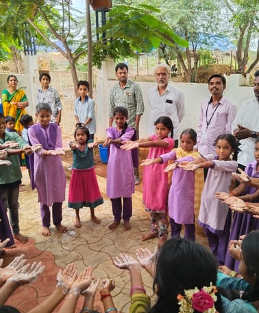 a group of people standing around a circle of hands
