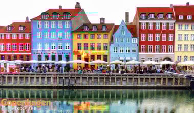 a boat docked in a harbor with people walking by