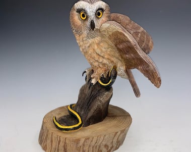 a bird perched on a tree stump 