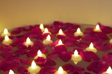 a bowl of candles with candles on a table