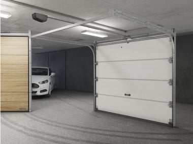 a car parked in a garage with a white car