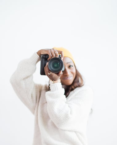Portrait of Shade holding a camera