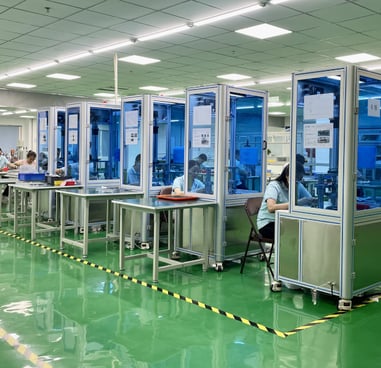 a factory floor with a lot of people working on machines