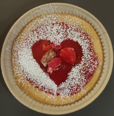 a pie crust pie with a heart shaped piece of cake
