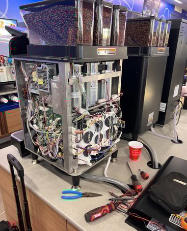 BUNN coffee machine with wiring and circuit boards exposed during repair.