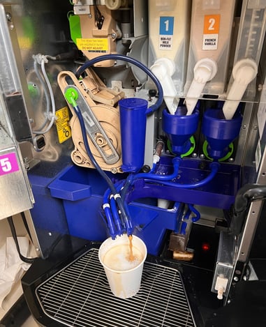 Nescafé Krea coffee machine showing dual grinder system and internal components.