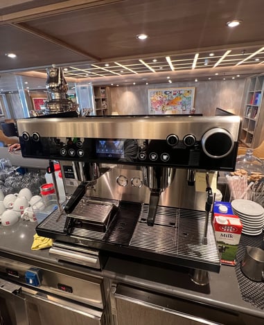 Schaerer Barista espresso machine in a luxury lounge setup with clean cups ready for service.
