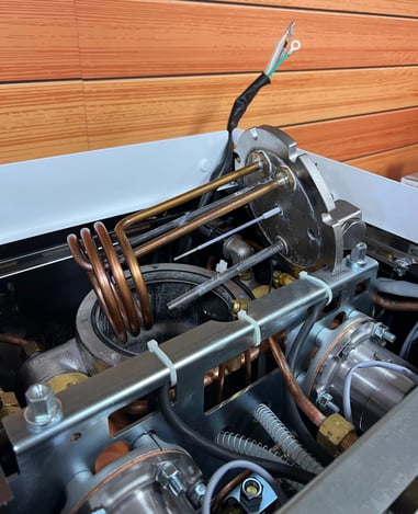 Internal boiler heating element exposed on La Spaziale espresso machine during repair