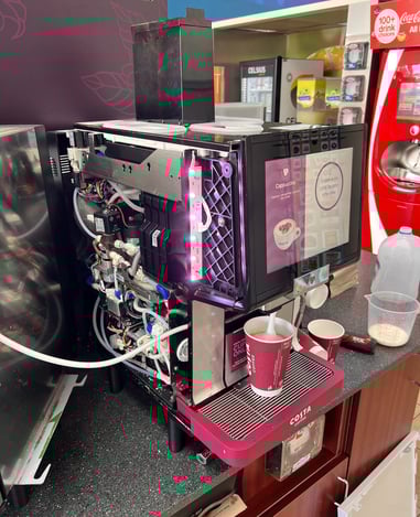 Costa Coffee self-service machine with panel open for internal inspection.
