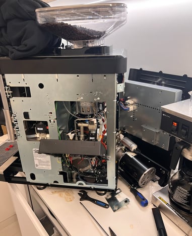 La Cimbali espresso machine undergoing internal service and inspection.