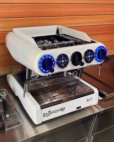 La Spaziale S21 espresso machine set up with grinder and tools ready for calibration