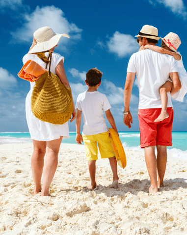 a family of three children walking on the beach